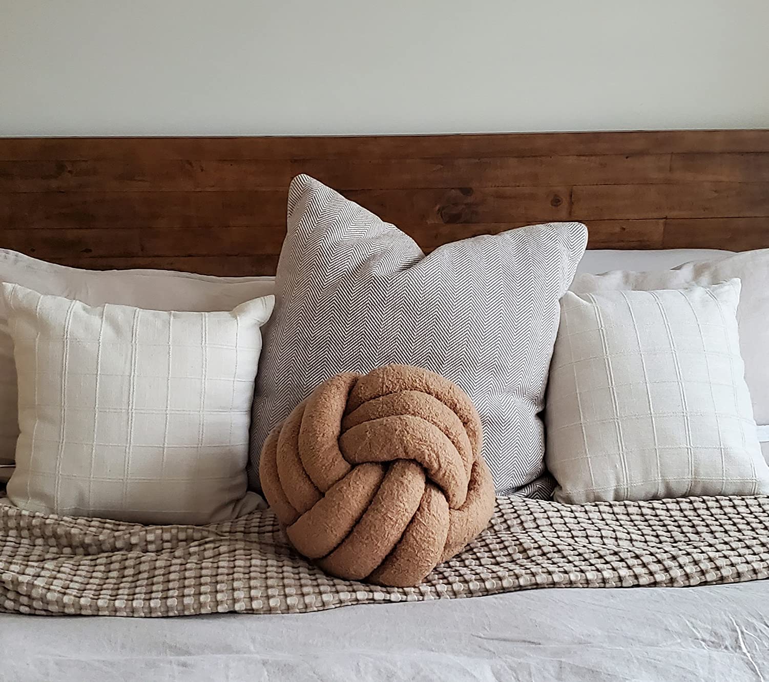 8. Add Playful Visual Interest to Armchairs with a Cozy Bouclé Knot Accent Pillow