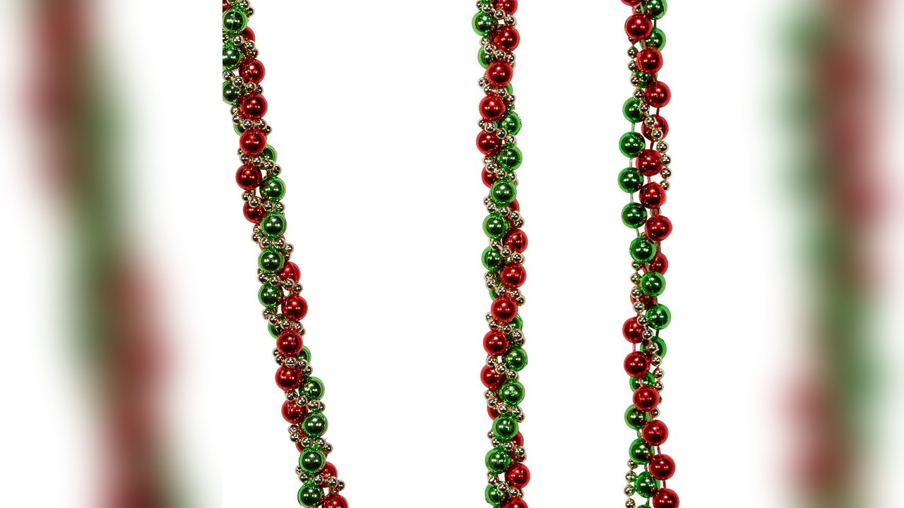 Red green and gold bead garland twisted around a christmas tree, 90s christmas tree
