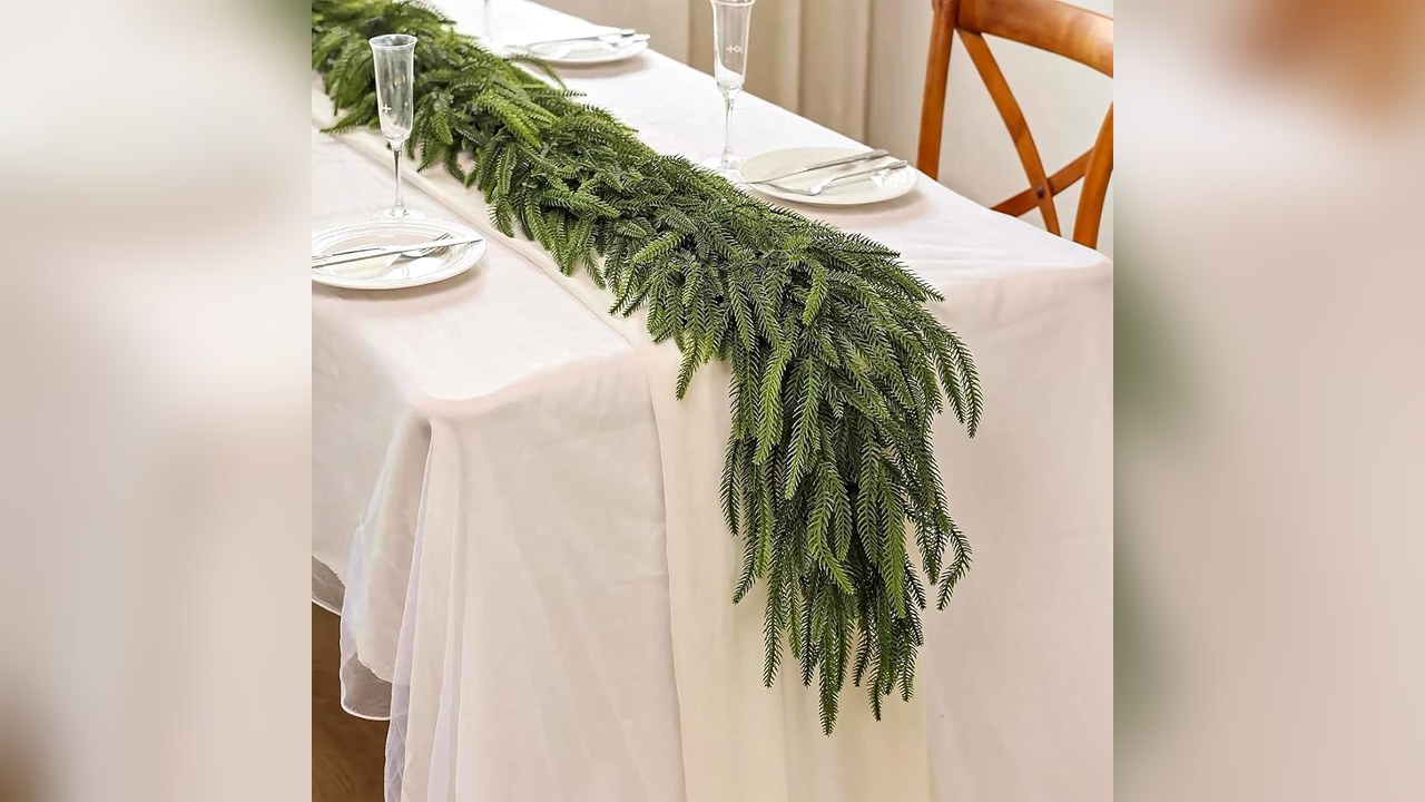 Norfolk pine garland down the center of a Christmas table