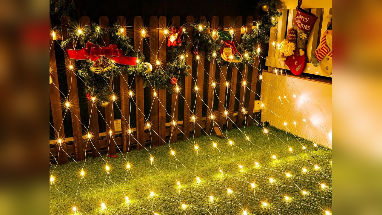 Outdoor net lights draped over front yard bushes