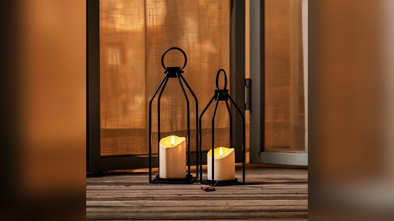 Pair of black metal lanterns with candles on both ends of a mantel