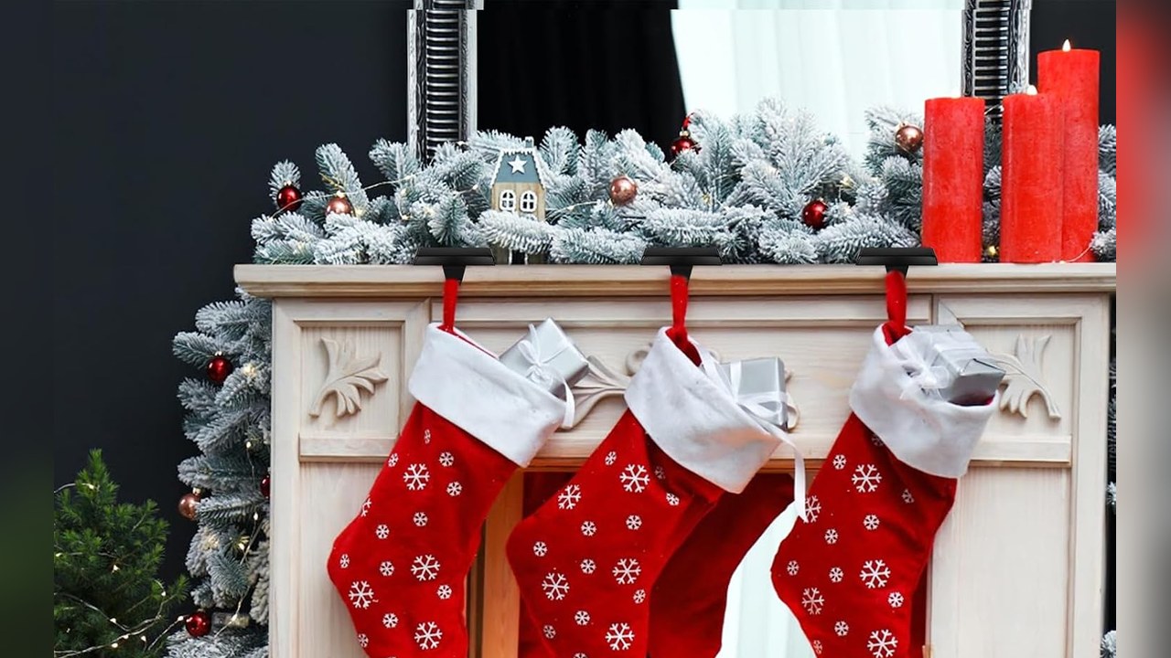 Weighted black stocking holders sitting on top of a mantel