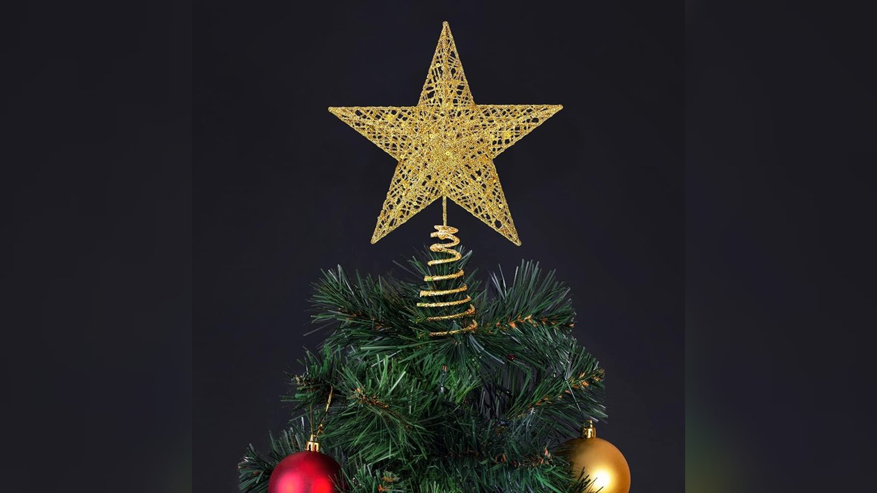 Gold glitter star Christmas tree topper on a green tree with red and gold ornaments, christmas tree topper ideas