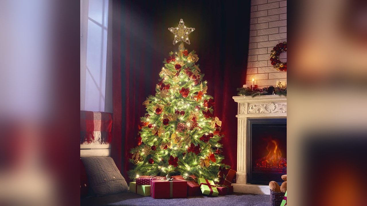 Lighted rattan star Christmas tree topper on a decorated tree by a fireplace, christmas tree topper ideas