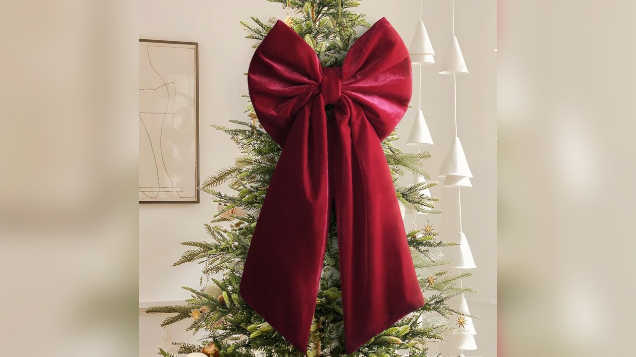 Large red velvet bow Christmas tree topper on a tree with white and silver ornaments, christmas tree topper ideas
