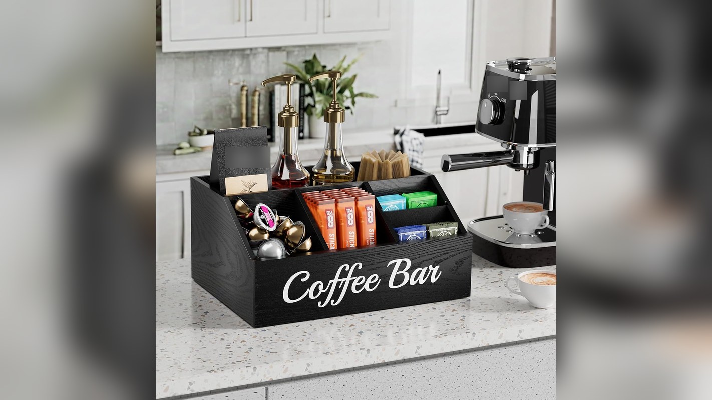 Wooden coffee station organizer holding pods and sugar packets on a counter