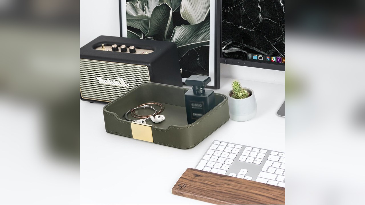 SANZIE khaki green leather valet tray holding bracelets and earbuds on white desk