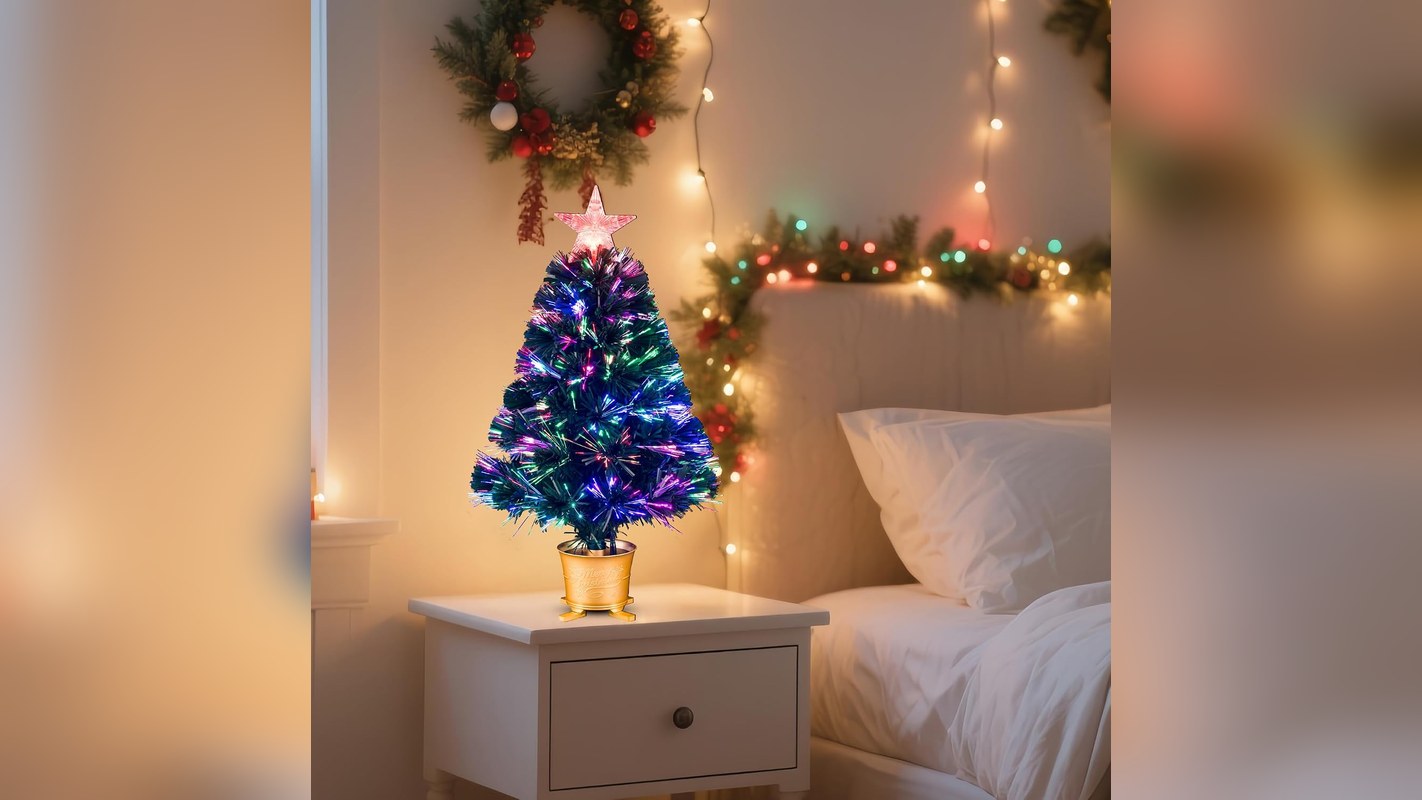 Small fiber optic Christmas tree glowing on a nightstand
