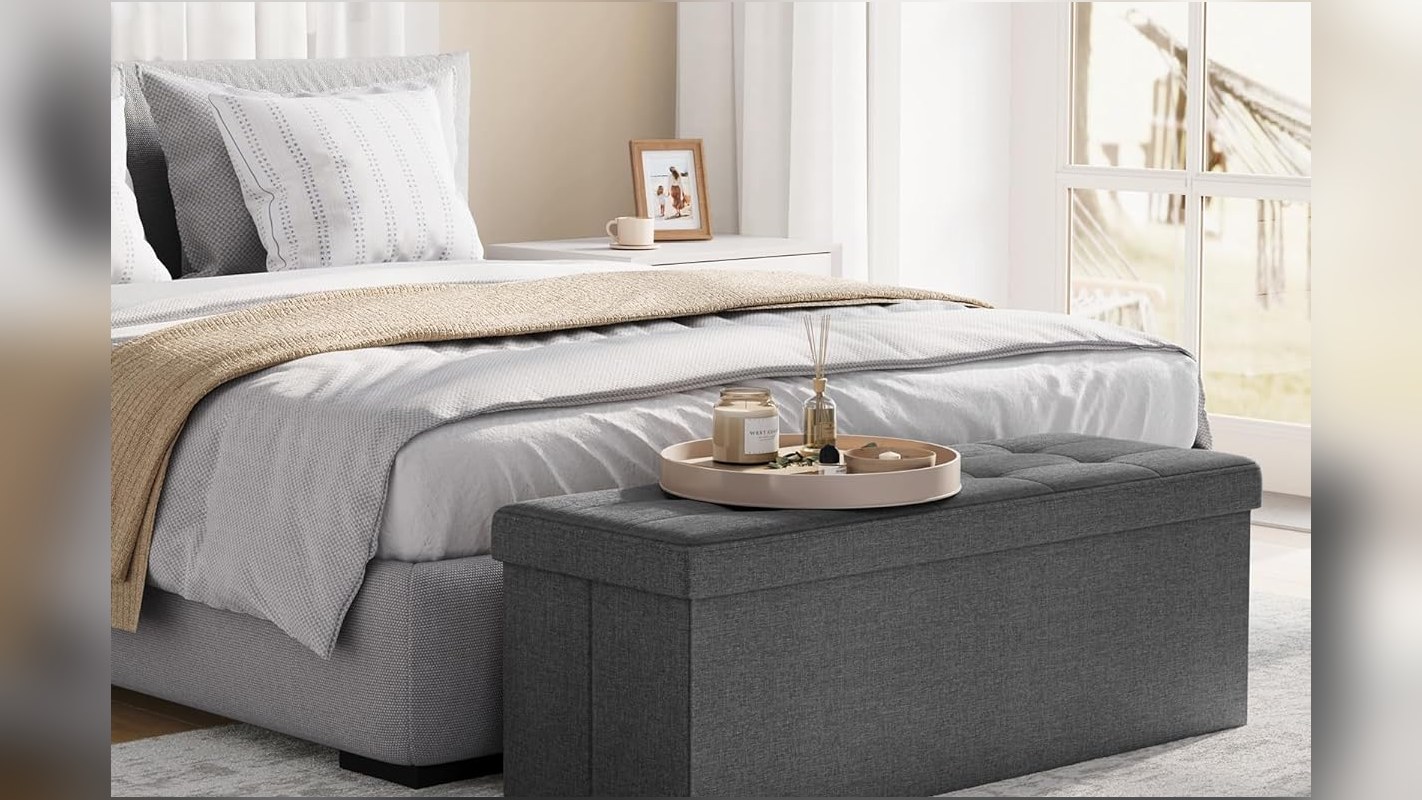 Folding storage ottoman used as a seat in a living room