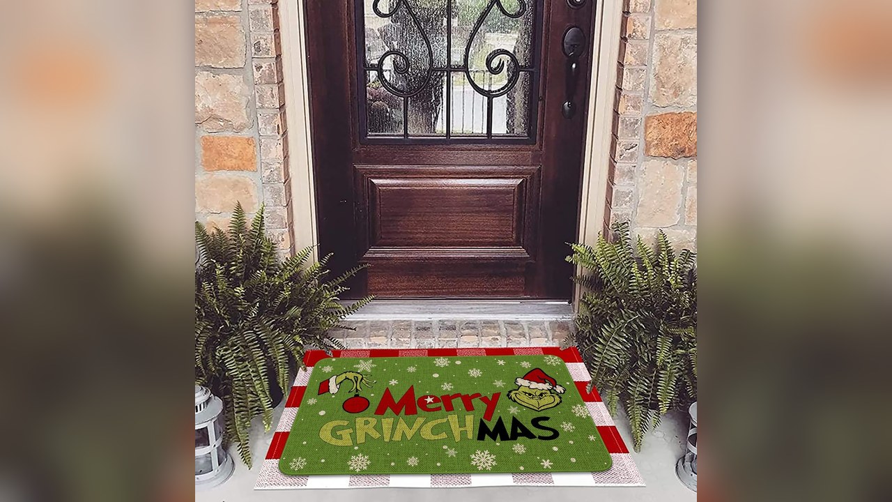 Merry Grinchmas green non-slip doormat at a front door