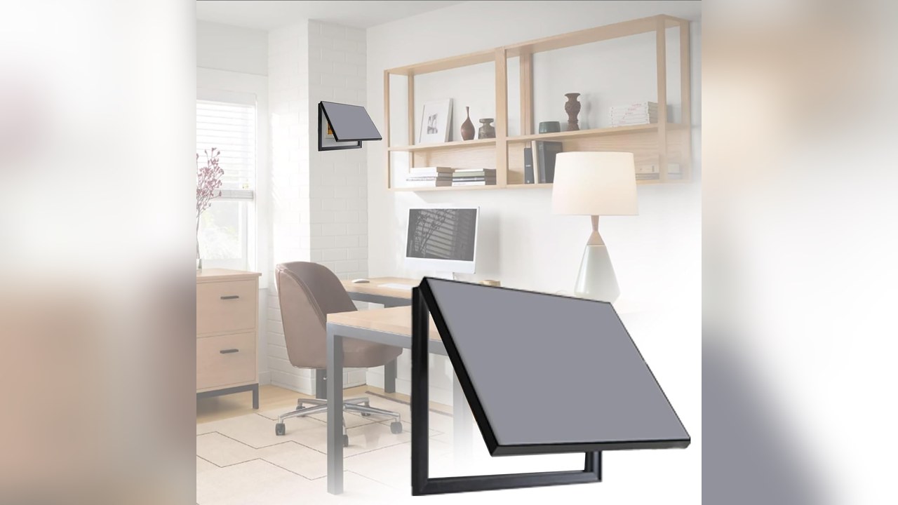 Black hinged art frame cover flipped up on a wall to show a small electrical panel behind it