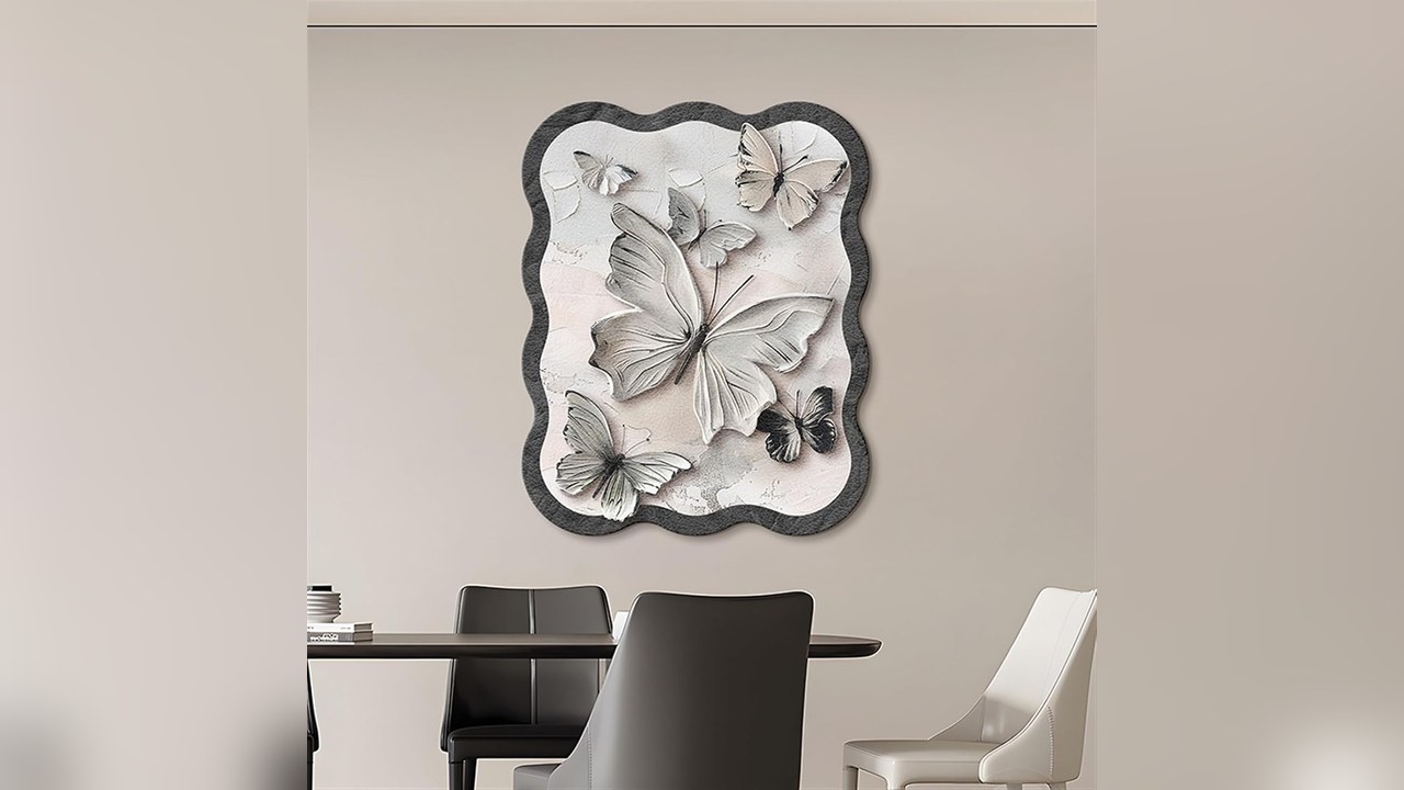 Wavy-edged butterfly art magnetic breaker box cover hanging on a living room wall