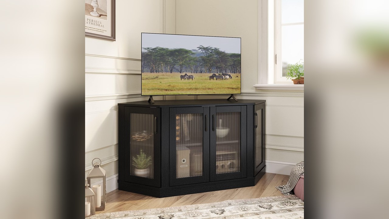 Panana black corner TV stand with fluted glass-look doors and a TV on top in a room corner