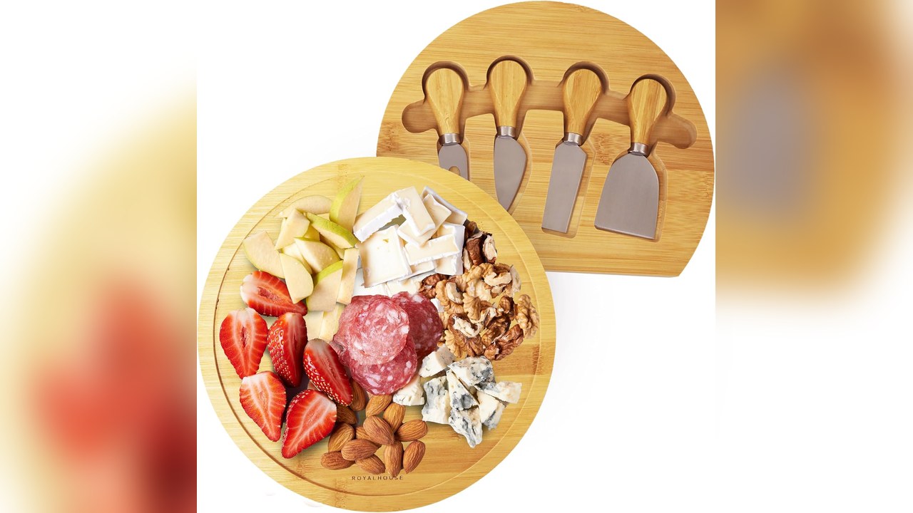 Round bamboo charcuterie board with cheese, fruit and crackers