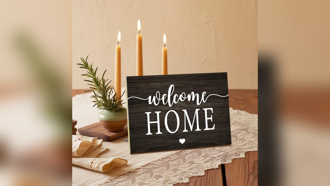Wooden welcome sign on an entry table for a housewarming party