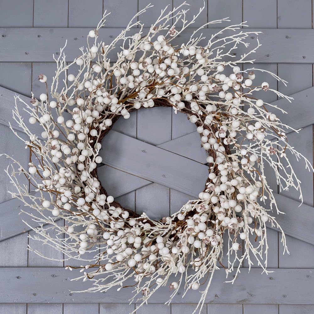 Artificial white berry winter wreath hanging on a front door