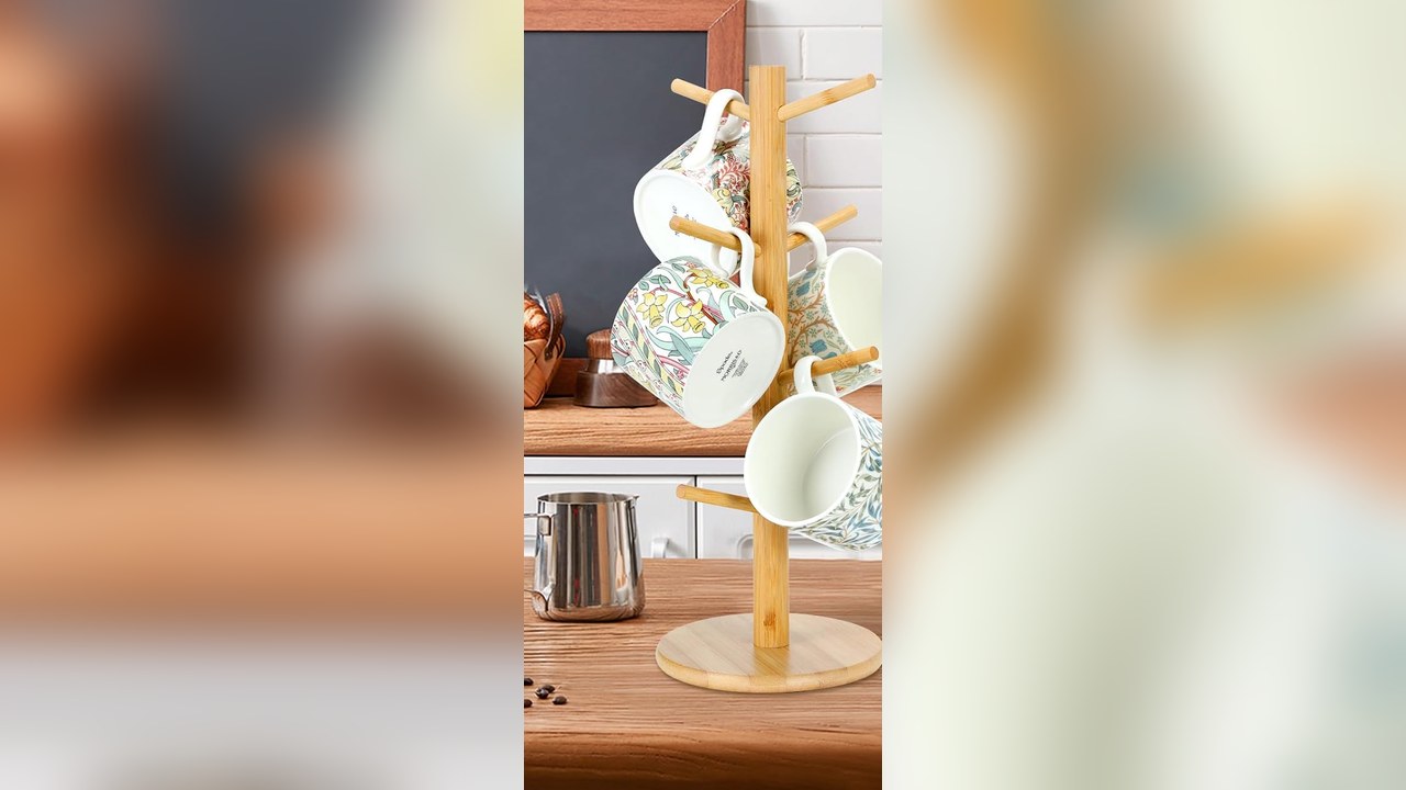 wooden mug tree holding Christmas mugs beside a hot cocoa station