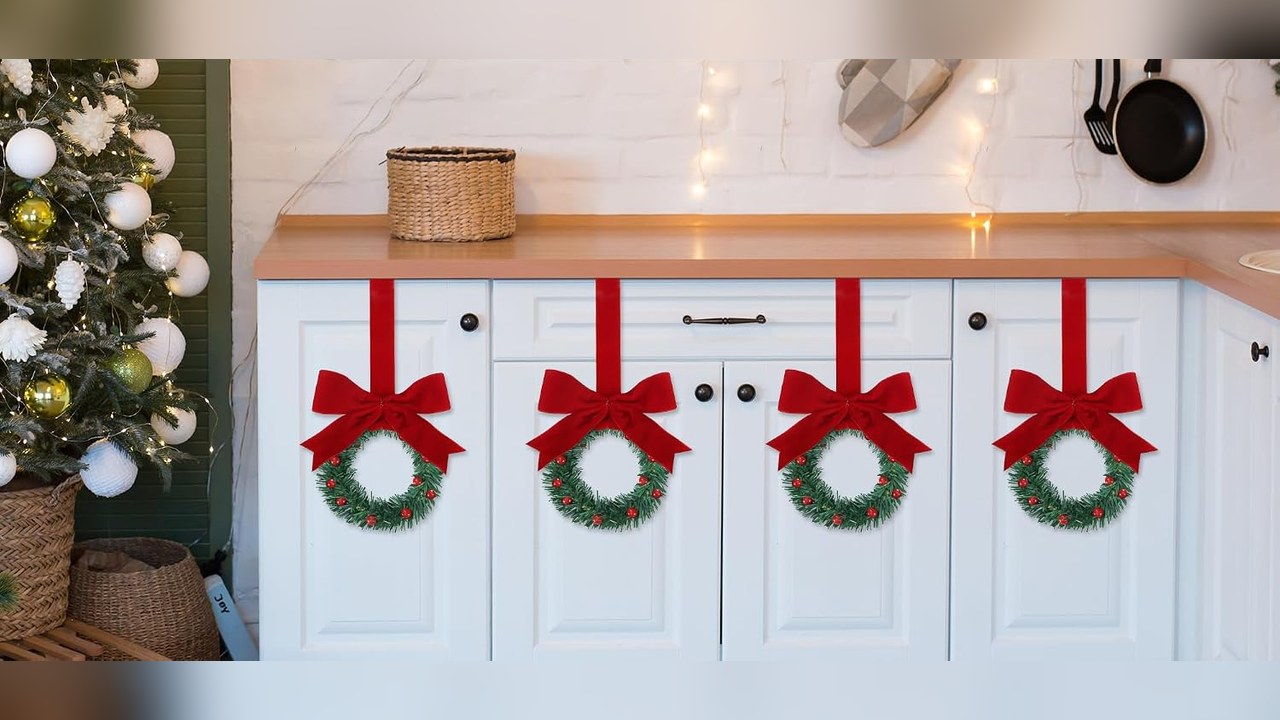 mini Christmas wreaths hanging on kitchen cabinet doors