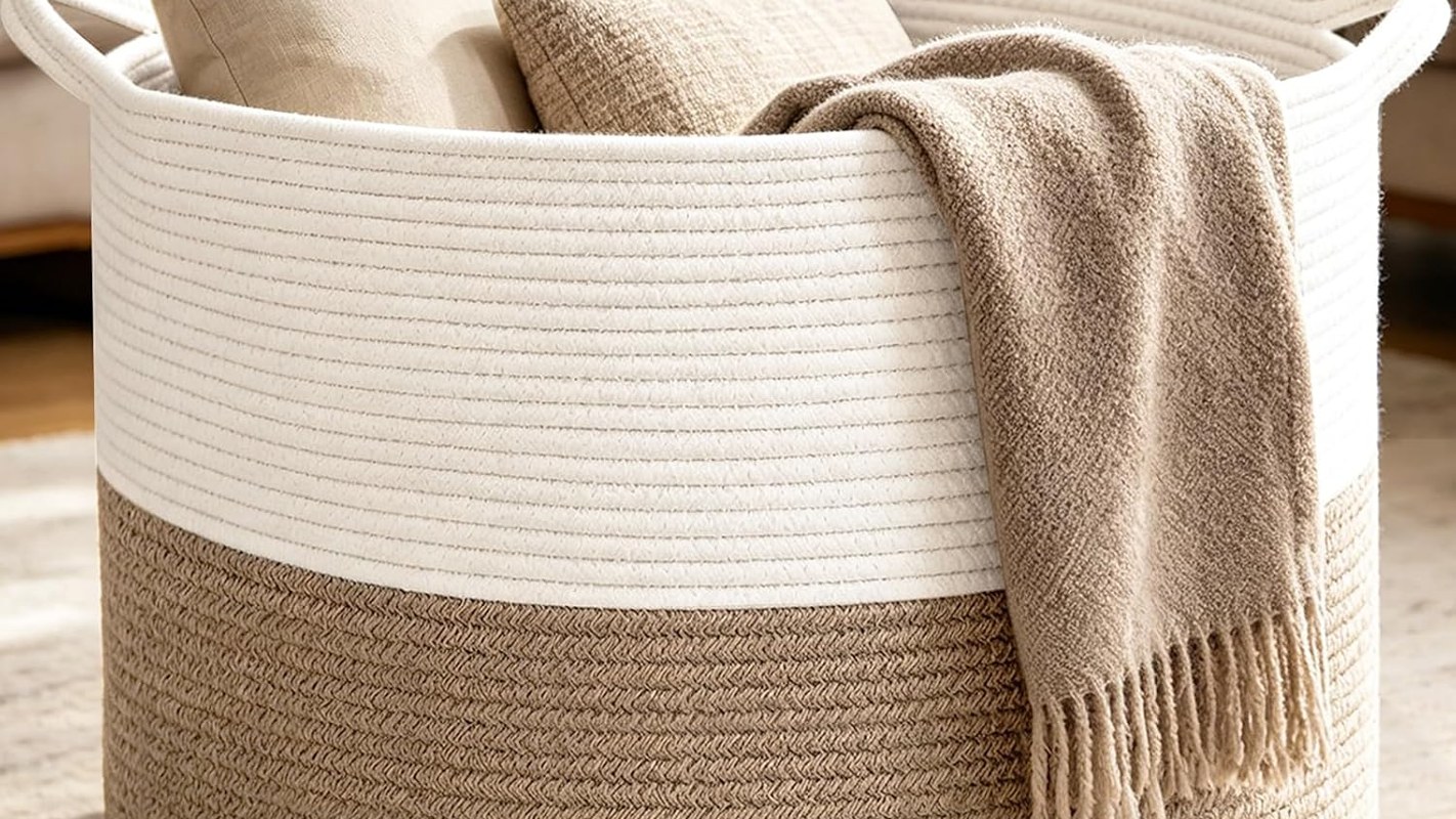 Large round woven cotton rope blanket basket beside a sofa