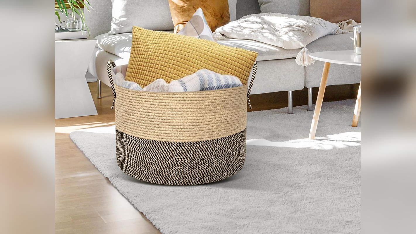 Lidded cotton rope blanket basket beside a gray sofa