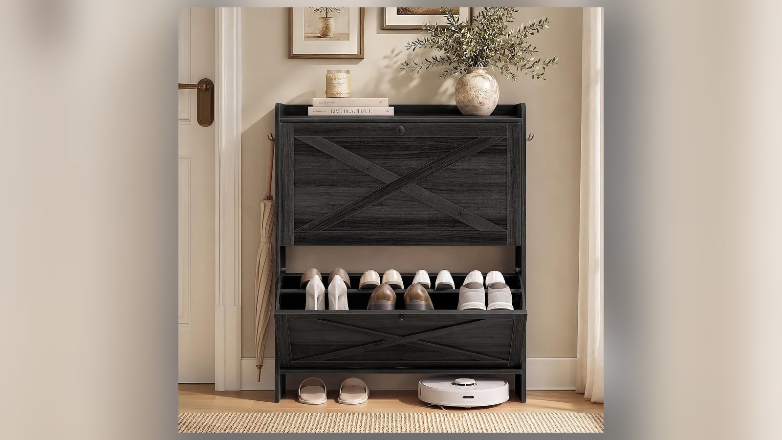 Narrow black flip-drawer shoe cabinet in small entryway with slippers and plant on top