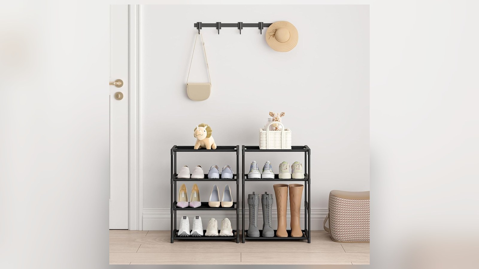 Two narrow black four-tier shoe racks with sneakers, heels and boots beside entryway door and coat hooks