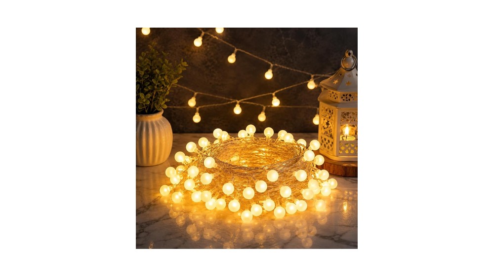 Warm white frosted ball string lights draped above a headboard