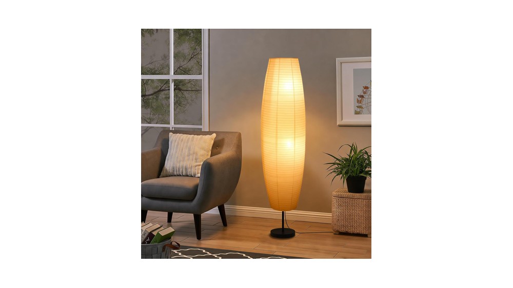 Tall slim rice paper floor lamp glowing in a corner behind an armchair
