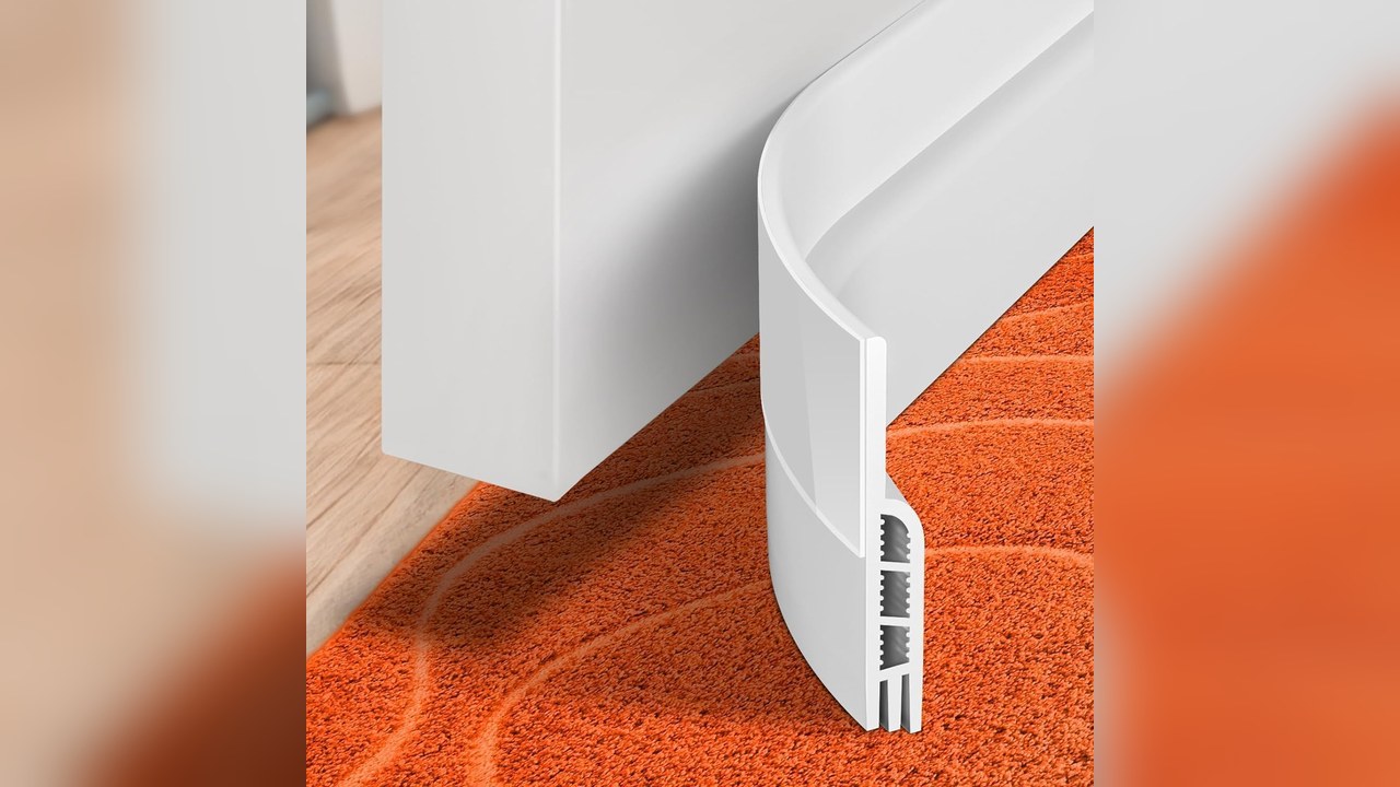 Stick-on door draft stopper along the bottom of a door