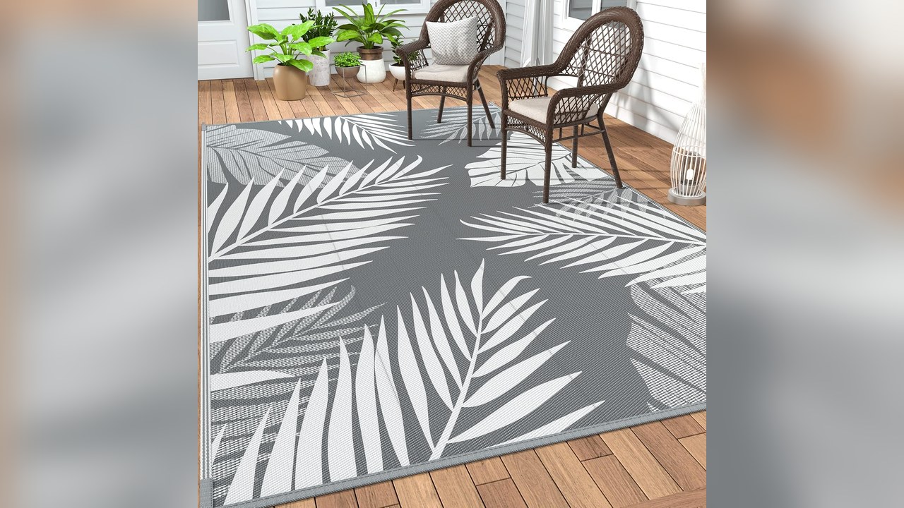 Grey and white waterproof outdoor rug on a porch floor