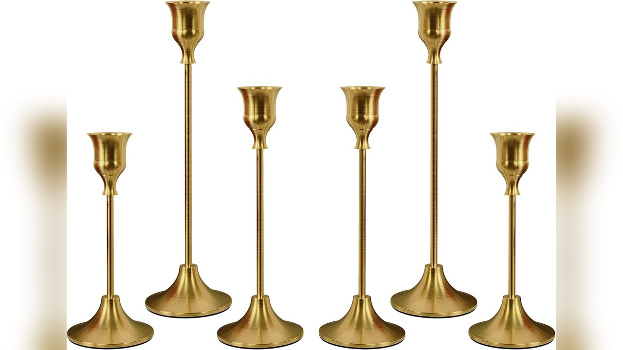 Brass taper candlesticks on a styled shelf