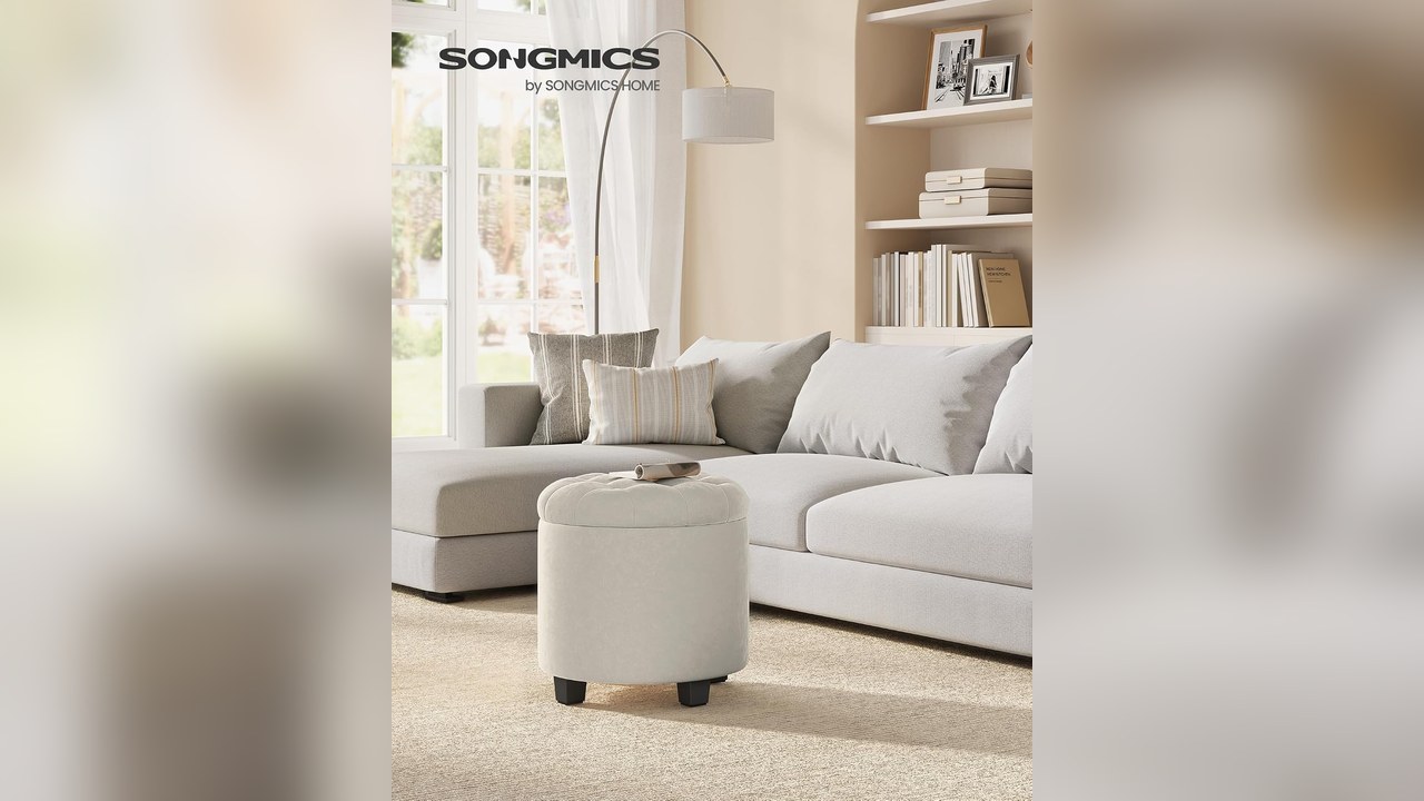 Round tufted velvet storage ottoman by a sofa in a small apartment