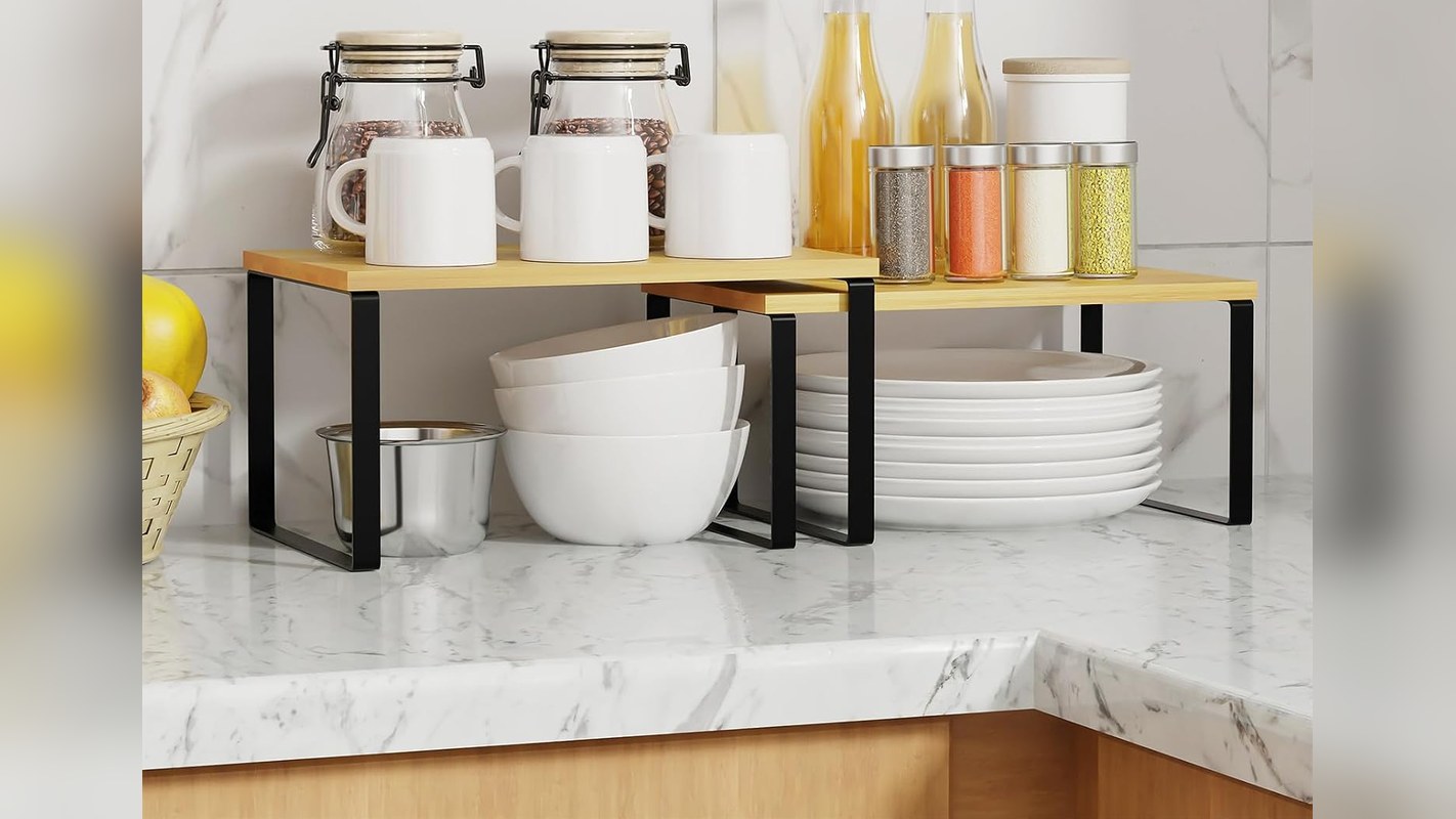 Bamboo and metal counter risers holding kitchen items in two levels