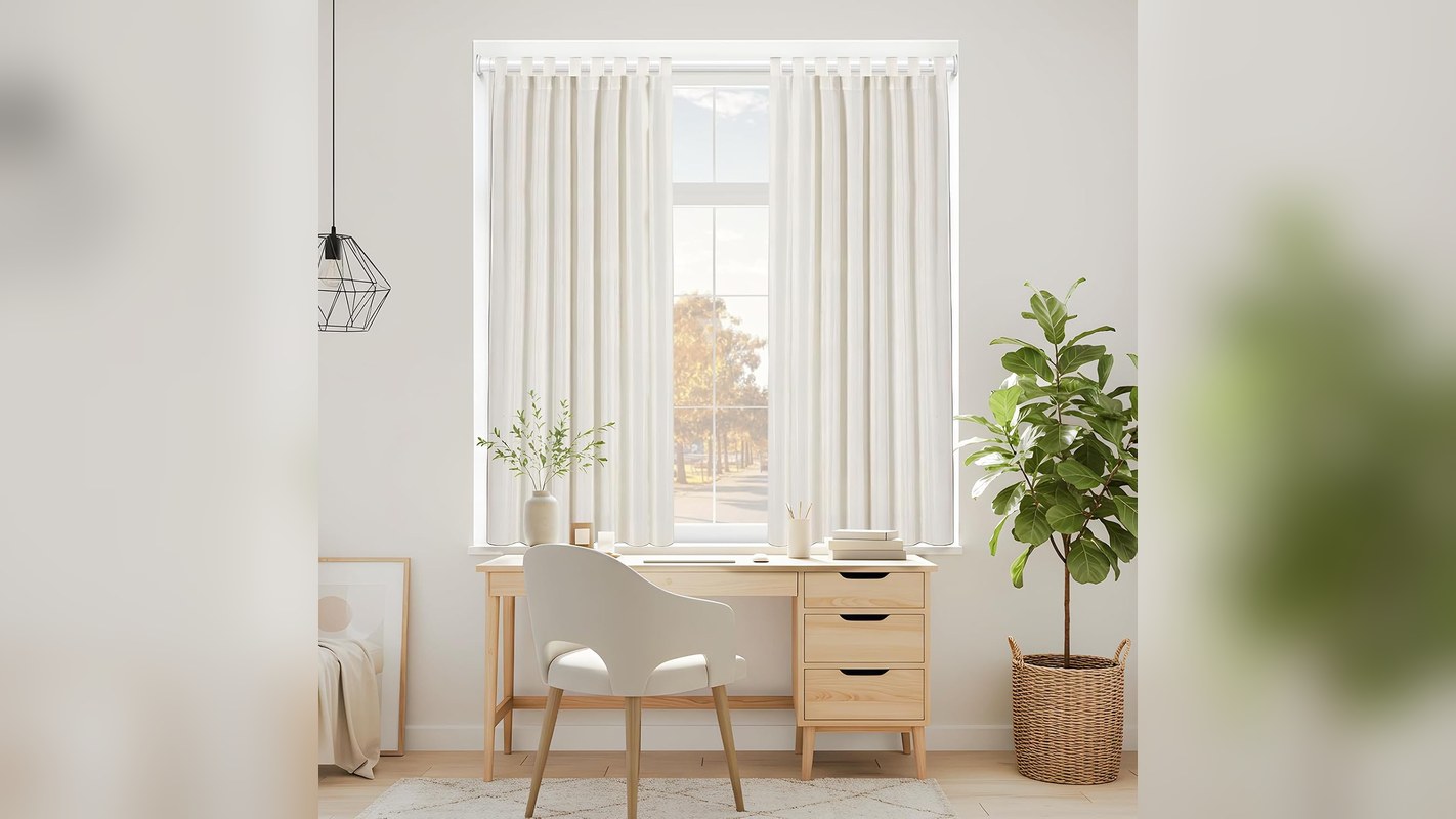 White tension curtain rod holding light curtains in a rental window