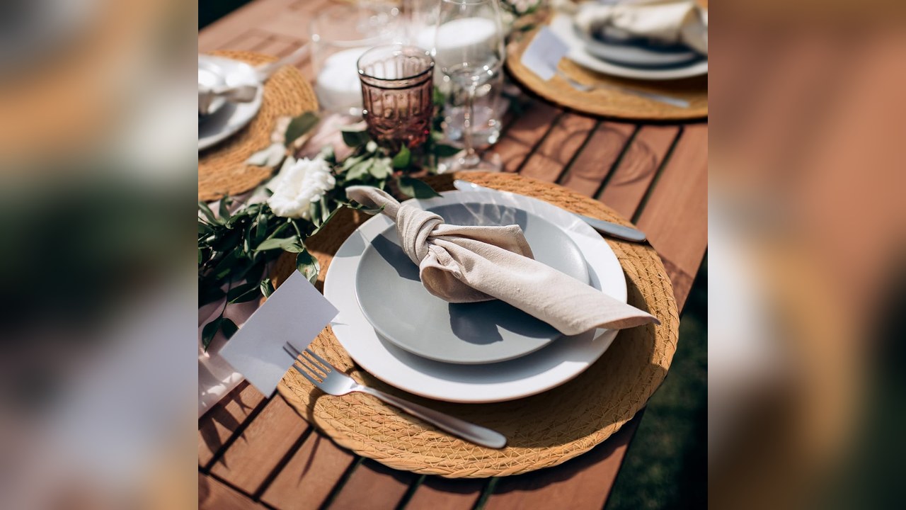 Woven round charger placemats set under plates on a Thanksgiving table