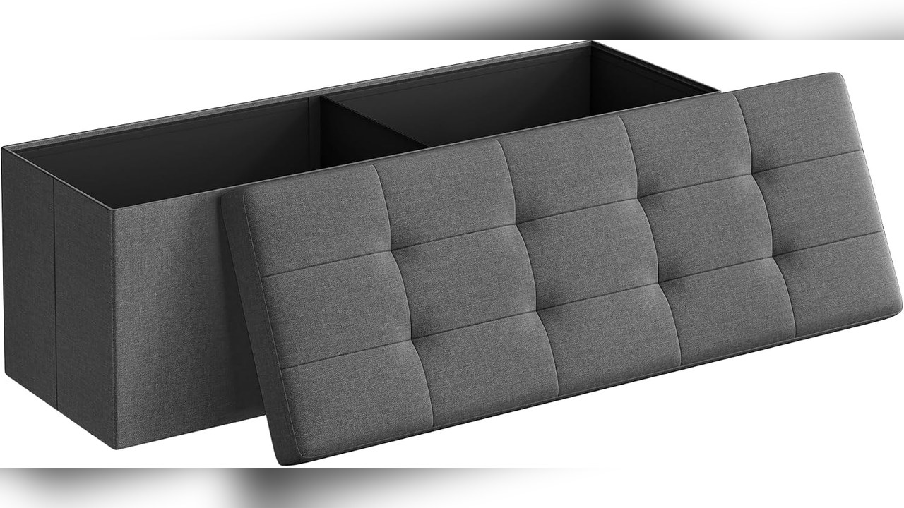 Dark gray folding storage ottoman bench with the tufted lid lifted to show the open storage inside