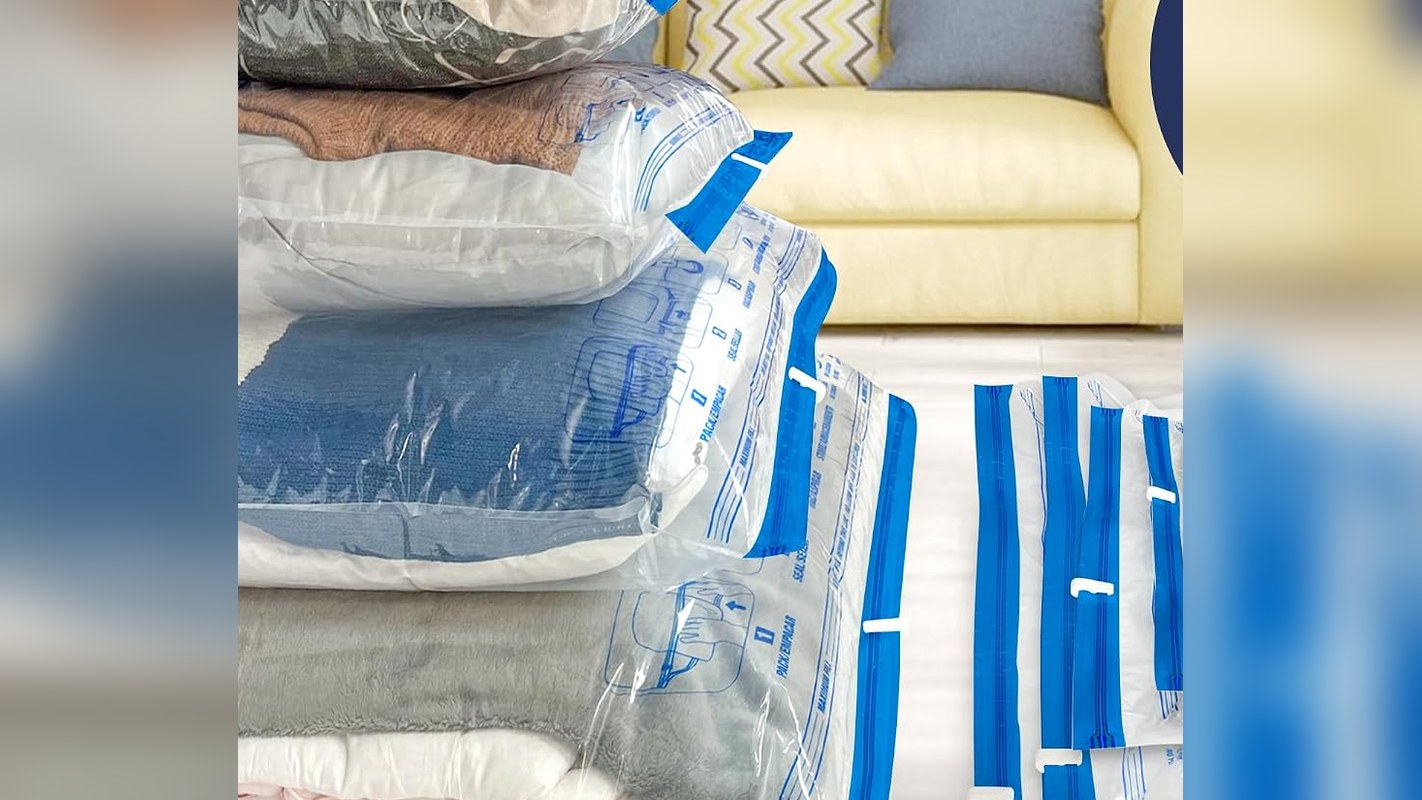 Vacuum storage bags compressing bulky bedding and blankets into flat stacks
