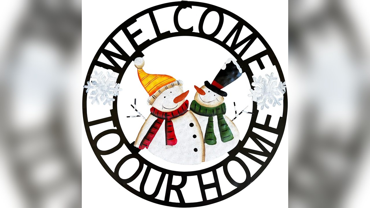 Hand painted metal snowman welcome sign hanging on a door