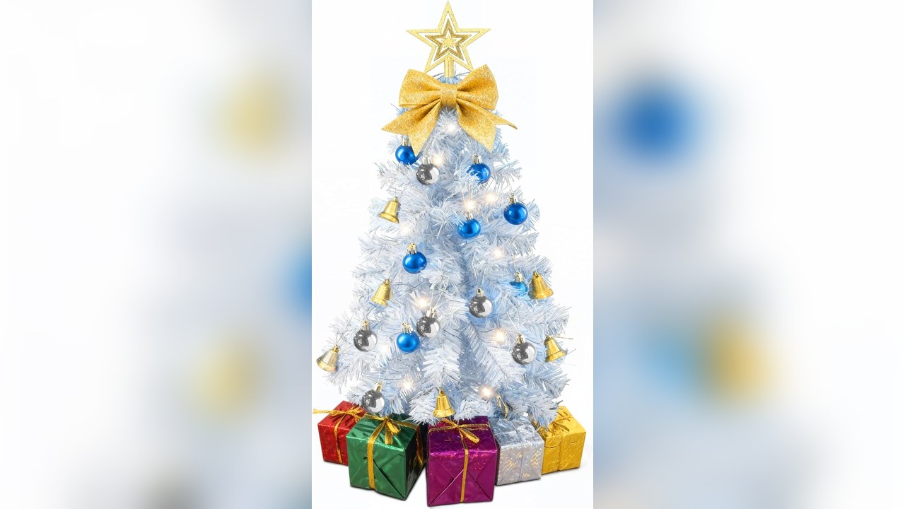 Small white tabletop tree with warm lights on an office desk