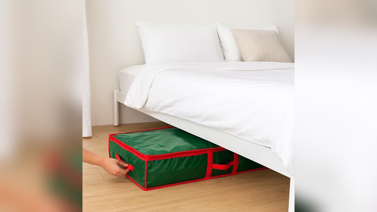 Flat green wrapping paper storage bag being slid under a bed