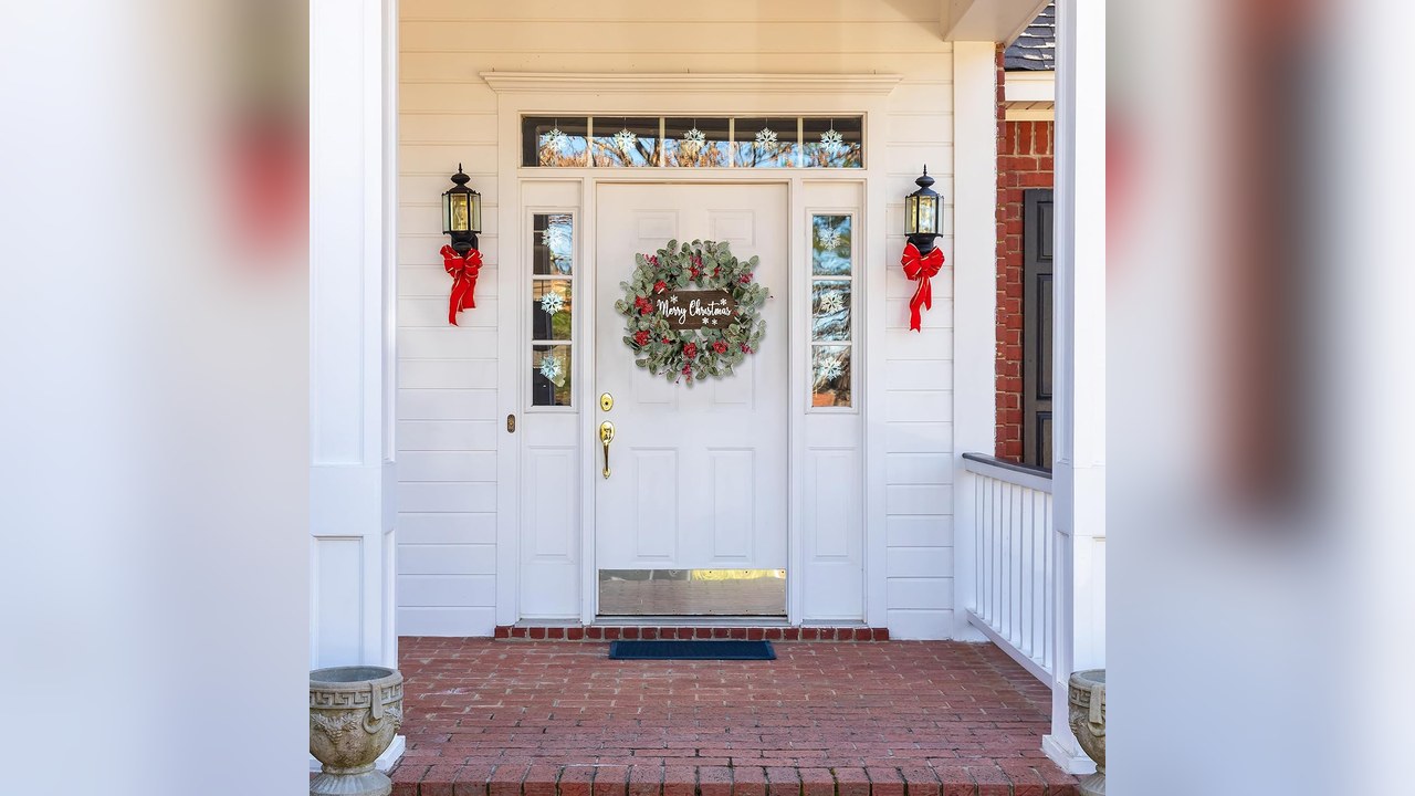 Red berry Christmas wreath on a front door
